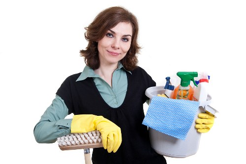 Local cleaner treating stains on a living room sofa