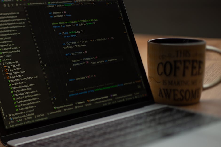 Close-up image of a computer screen displaying colorful coding syntax in various shades of green, yellow, purple, and orange on a dark background. The code appears to be HTML or CSS, with visible elem